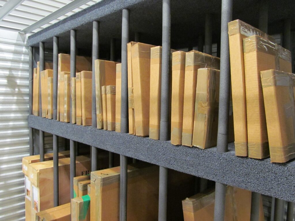 flat boxes organized in a sturdy, gray, metal shelving unit
